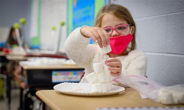 Girl builds marshmallow tower